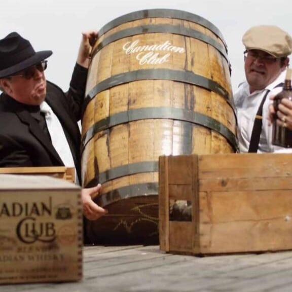 Two men holding Canadian Club barrel