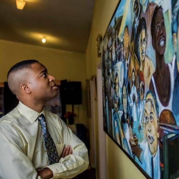 Man looking at black history art piece