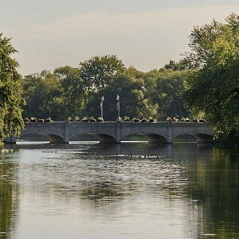 River with an arched bridge in the background